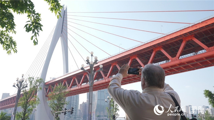 軻寶華“打卡”重慶東水門長江大橋。人民網(wǎng)記者 蘇纓翔攝