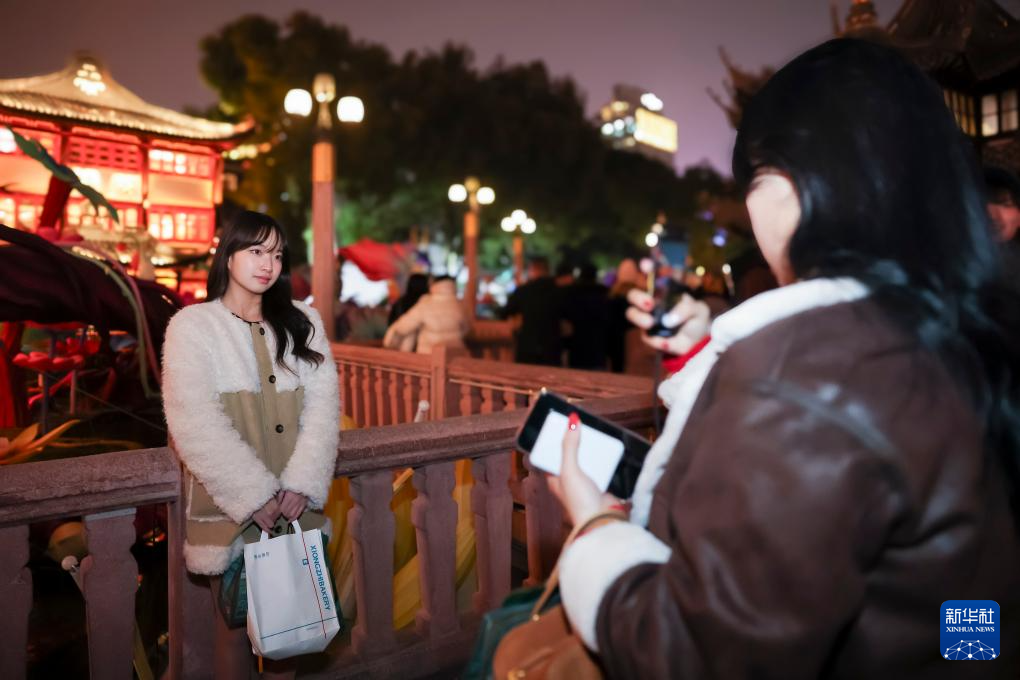 12月25日，韓國(guó)游客辜東恩（左）和宋慧彬在上海豫園商城九曲橋拍照。新華社記者 王翔 攝