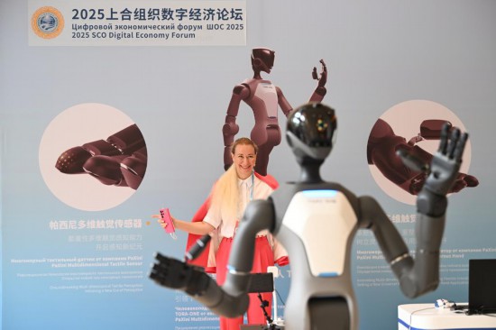 7月11日，參會(huì)嘉賓在2025上合組織數(shù)字經(jīng)濟(jì)論壇上體驗(yàn)操控人形機(jī)器人。新華社記者李然攝
